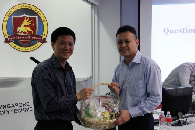 Mr Liew presenting a home-made SP gift hamper to Mr Ho
