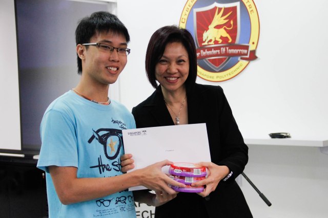 DMIT Director Ms Georgina Phua presenting Certificate of Merit to DISM CTF S1 2nd Runner-up team Digimon